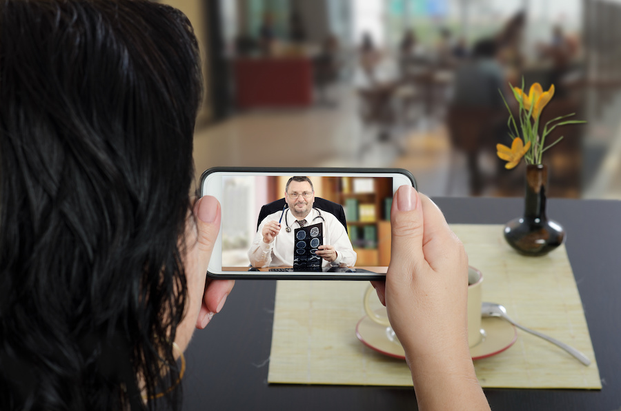 A woman consulting a doctor over videochat on a smartphone