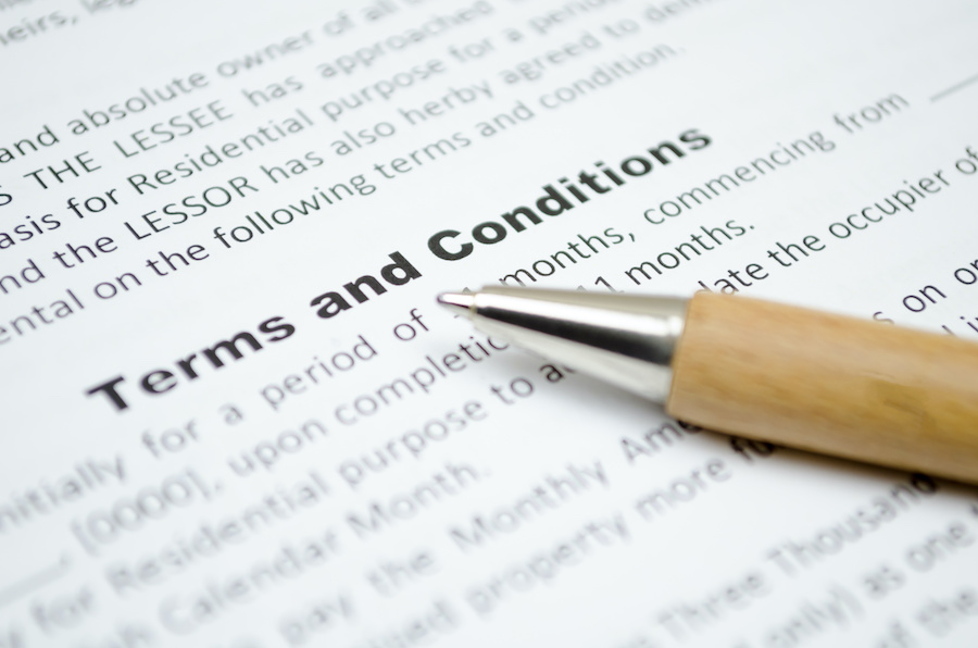 a contract displaying the heading "Terms and Conditions" and a pen