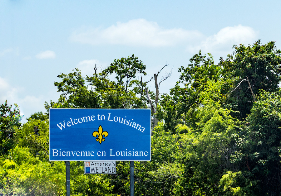 a roadside sign welcoming people to Louisiana, in English and French