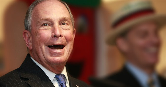 Former New York City mayor Michael Bloomberg smiles with his mouth open wide