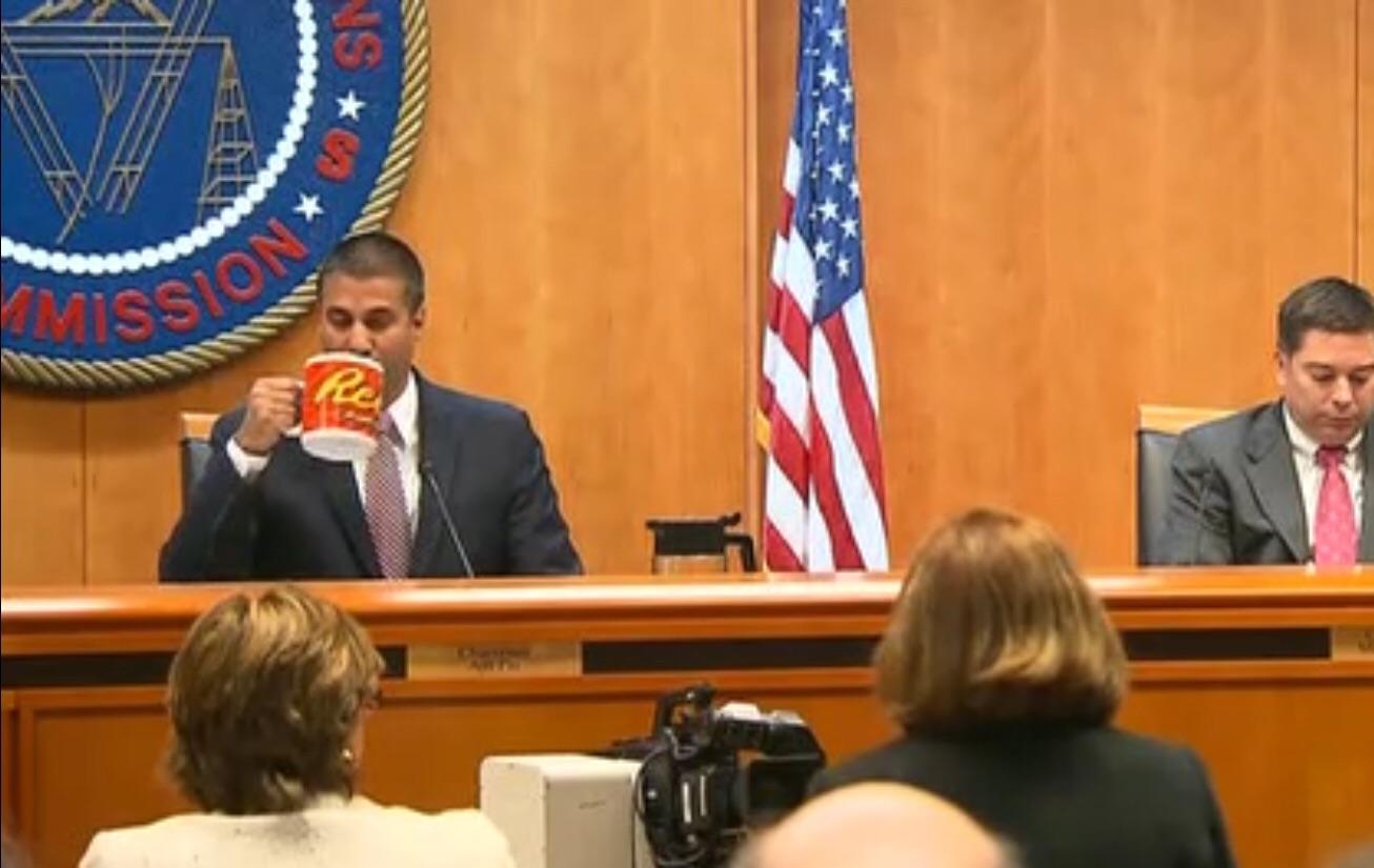 FCC Chairman Ajit Pai Drinks from a large mug with the Reese's peanut butter cup logo