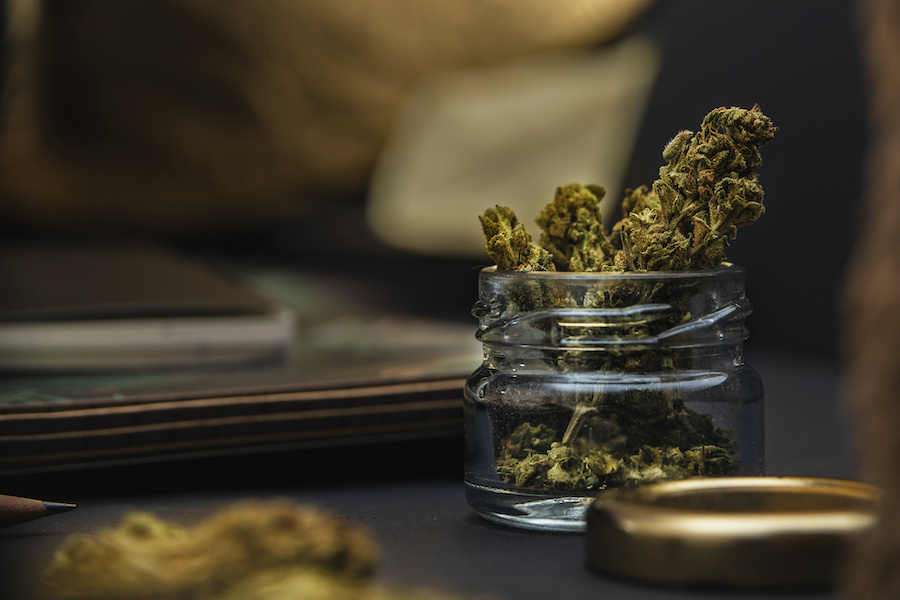 marijuana buds in a glass jar at a cannabis dispensary