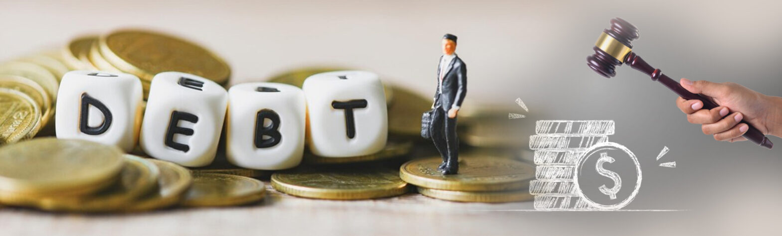 the word debt spelled out on little cubes atop a pile of coins